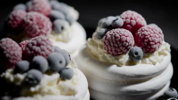 Delicious mini pavlova meringue desserts served with frozen frosty berries and mascarpone whipped cheese. Flat lay