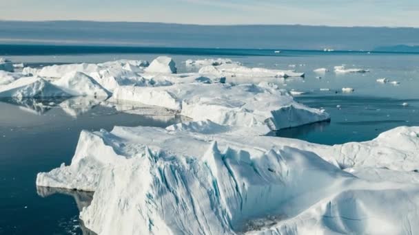 Global warming Aerial drone video timelapse hyperlapse - Greenland Iceberg landscape of Ilulissat icefjord with giant icebergs from melting glacier. Arctic nature heavily affected by climate change